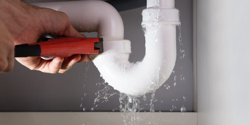 Close-up,Of,Male,Plumber,Fixing,White,Sink,Pipe,With,Adjustable Close-up,Of,Male,Plumber,Fixing,White,Sink,Pipe,With,Adjustable